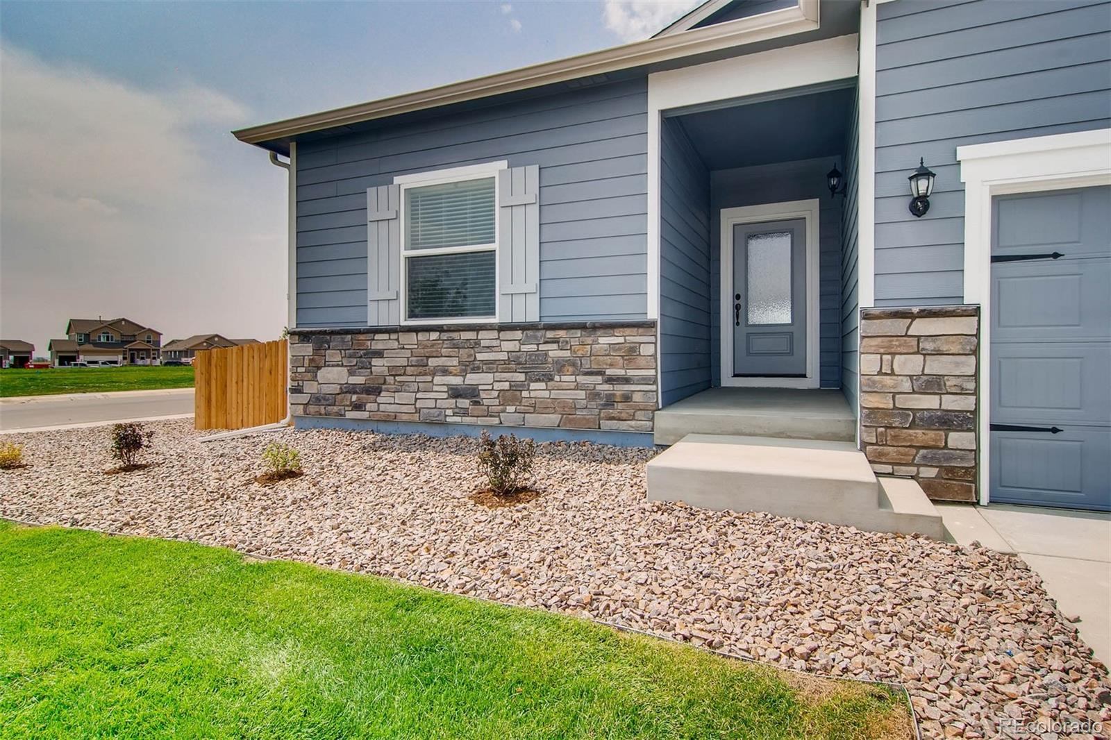 2299 Murray Street Mead, CO 80504 - Photo 3 of 17 a front view of a house with garden