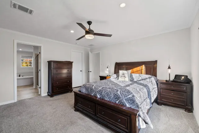 a bedroom with a bed and a refrigerator