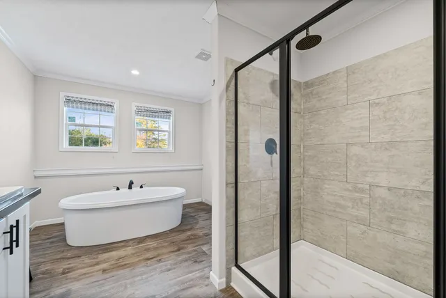 a spacious bathroom with a bathtub and sink