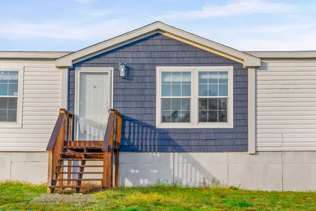 a view of front of house with a yard