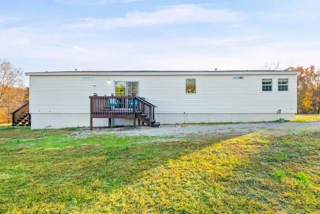 a house view with swimming pool in front of it