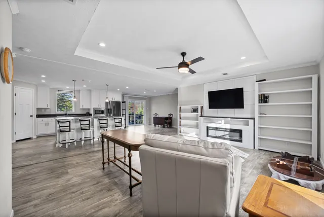 a living room with furniture and flat screen tv