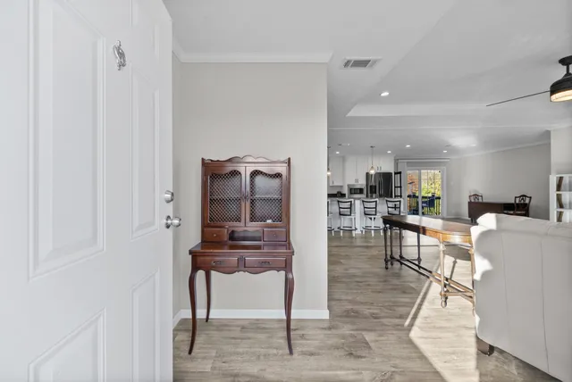a living room with furniture a dining table and kitchen view