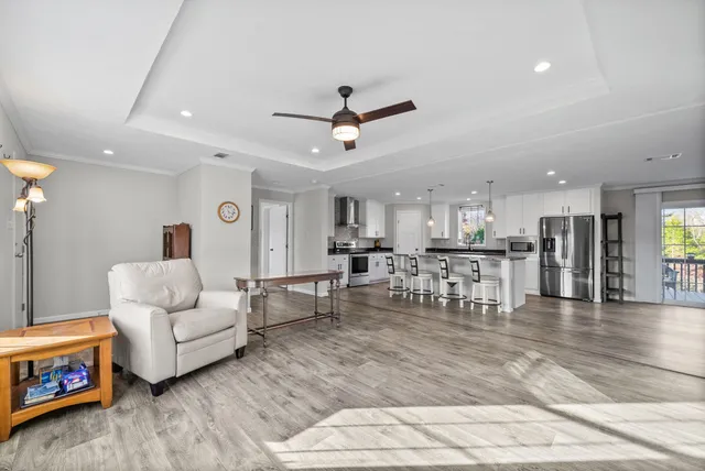 a living room with furniture and kitchen view