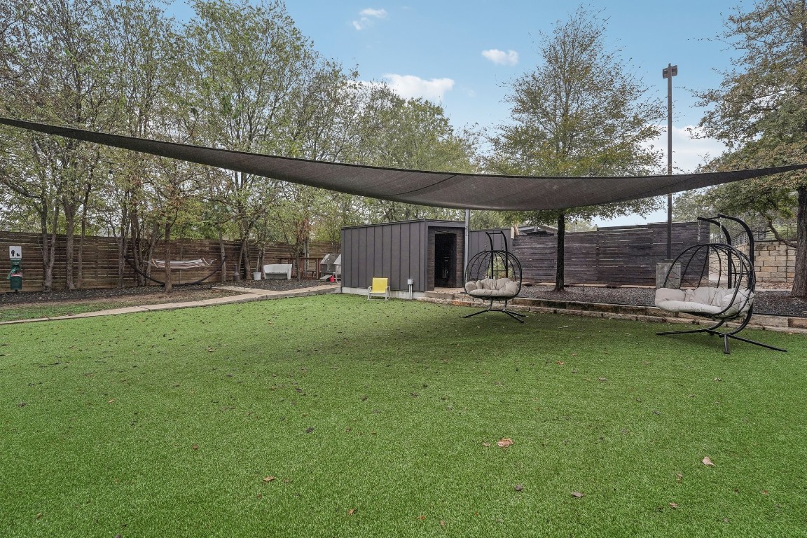 2505 Thornton Road, Unit 2307 Austin, TX 78704 - Photo 27 of 36 a view of a patio with a table chairs and a small yard