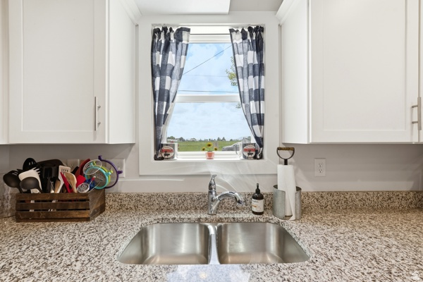 391 South 440th Street West Preston, ID 83263 - Photo 9 of 28 Stainless steel double basin sink with a chrome faucet, set against a speckled stone-finish countertop