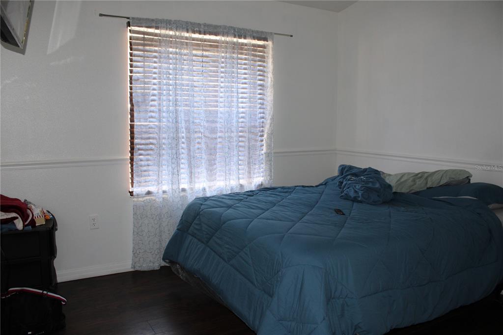 13475 Teaberry Lane Spring Hill, FL 34609 - Photo 13 of 21 a bed sitting in a bedroom next to a window
