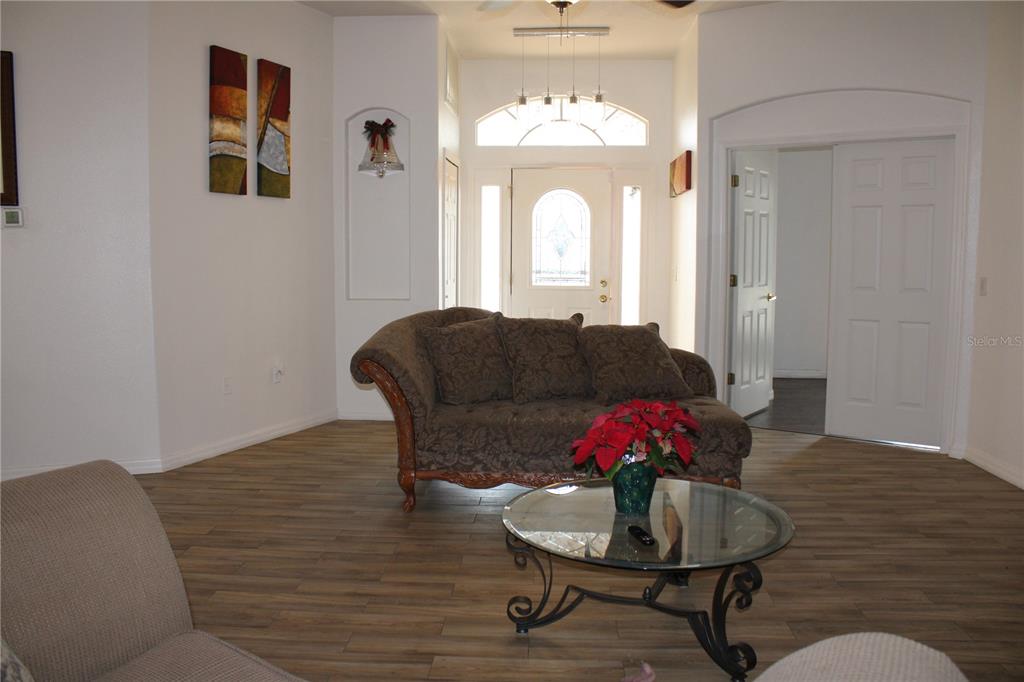 13475 Teaberry Lane Spring Hill, FL 34609 - Photo 3 of 21 a living room with furniture and a chandelier