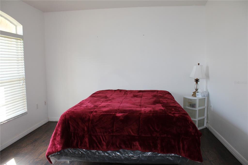 13475 Teaberry Lane Spring Hill, FL 34609 - Photo 5 of 21 a bedroom with a bed and a window