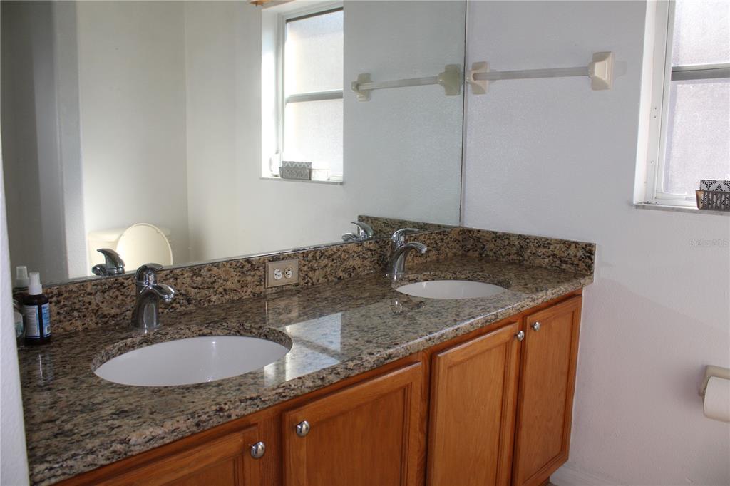 13475 Teaberry Lane Spring Hill, FL 34609 - Photo 7 of 21 a bathroom with a granite countertop sink and a mirror