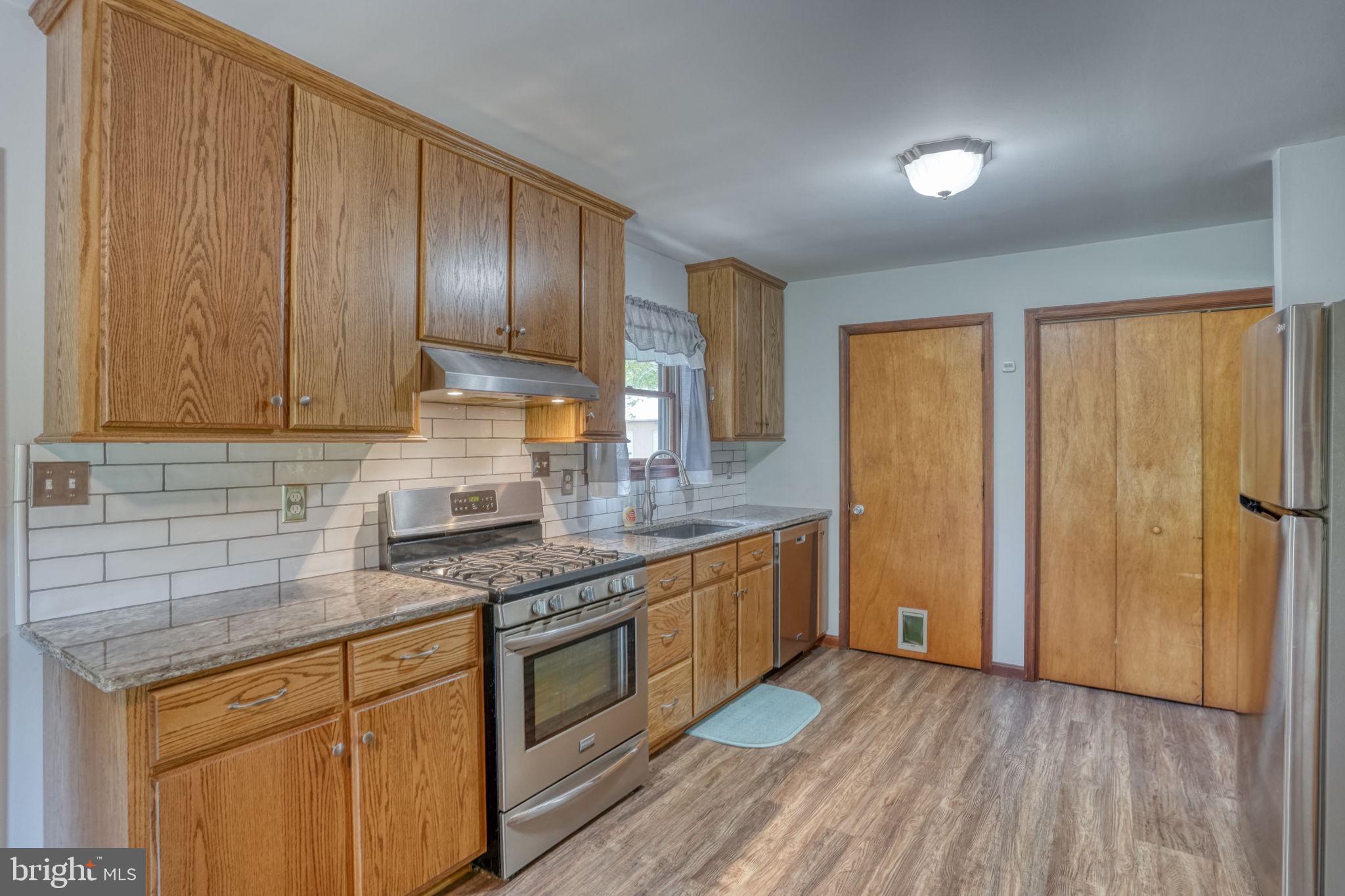 12484 Greensboro Road Greensboro, MD 21639 - Photo 16 of 50 Modern kitchen with warm wood accents.