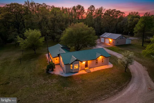 an aerial view of a house with outdoor space