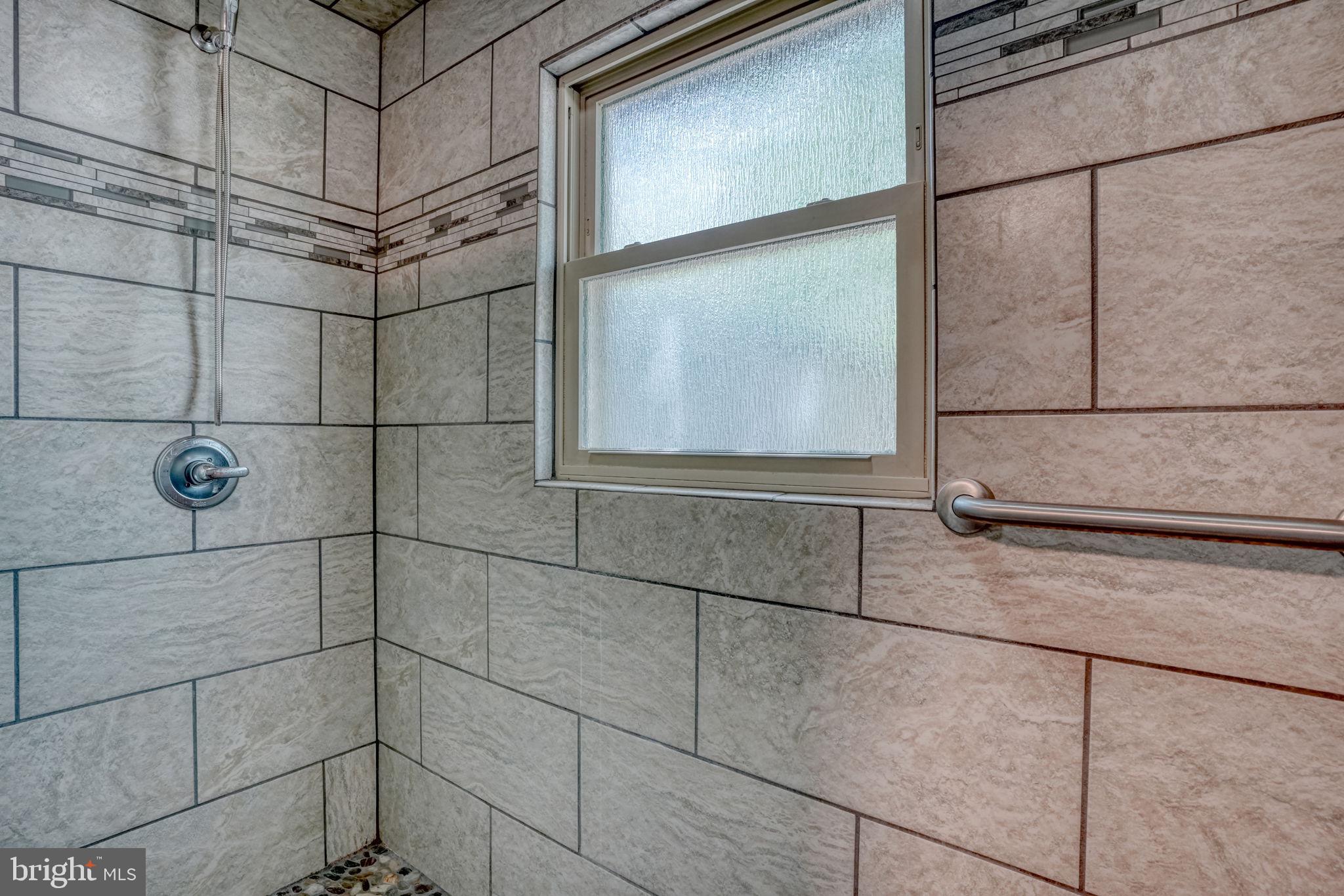 12484 Greensboro Road Greensboro, MD 21639 - Photo 25 of 50 Modern shower with elegant tiles.