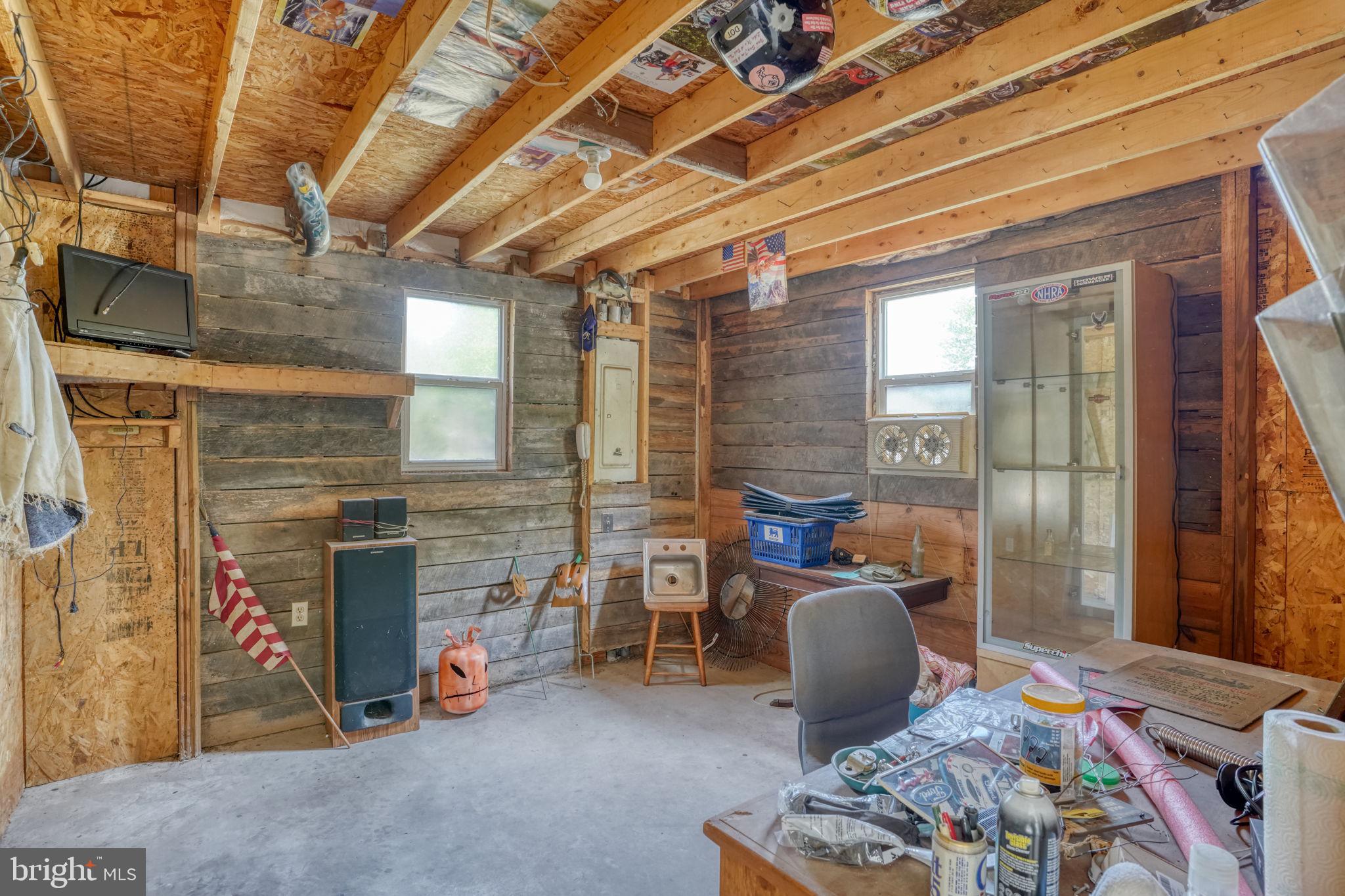 12484 Greensboro Road Greensboro, MD 21639 - Photo 44 of 50 Rustic workshop with wooden beams.