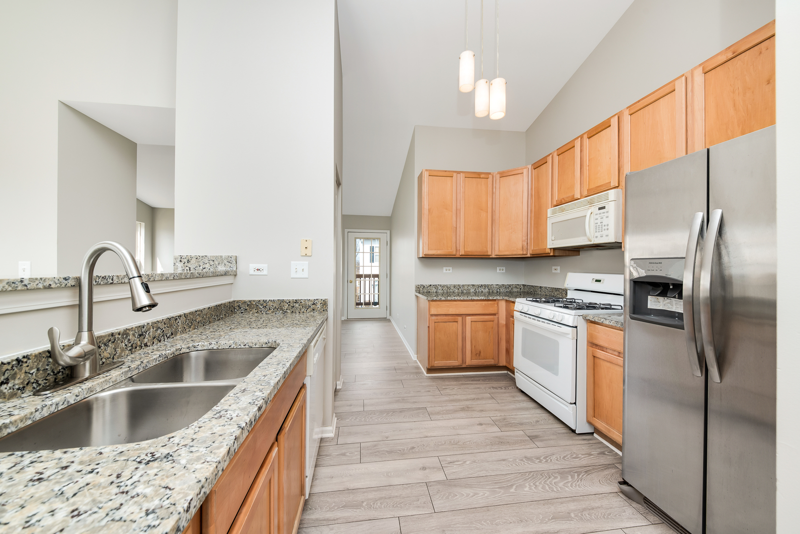 2450 Golf Ridge Circle, Unit 2450 Naperville, IL 60563 - Photo 4 of 17 a kitchen with stainless steel appliances granite countertop a sink a stove and refrigerator