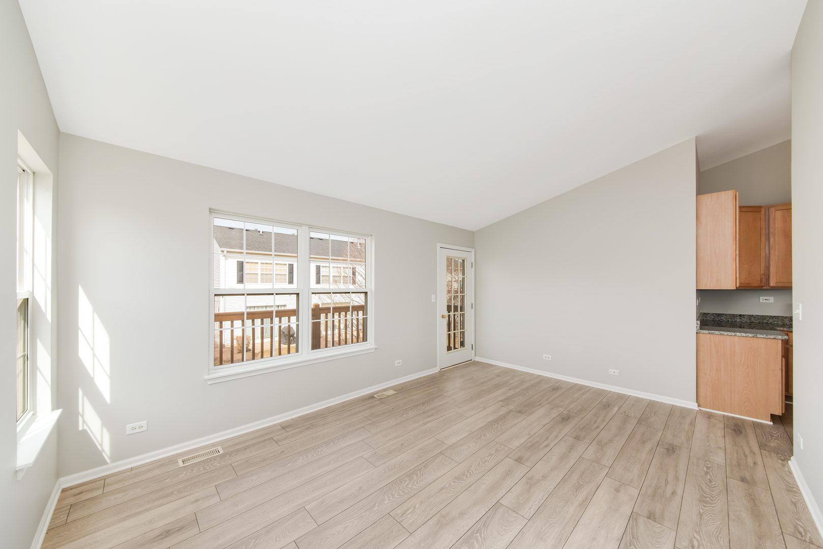 2450 Golf Ridge Circle, Unit 2450 Naperville, IL 60563 - Photo 8 of 17 an empty room with wooden floor and windows