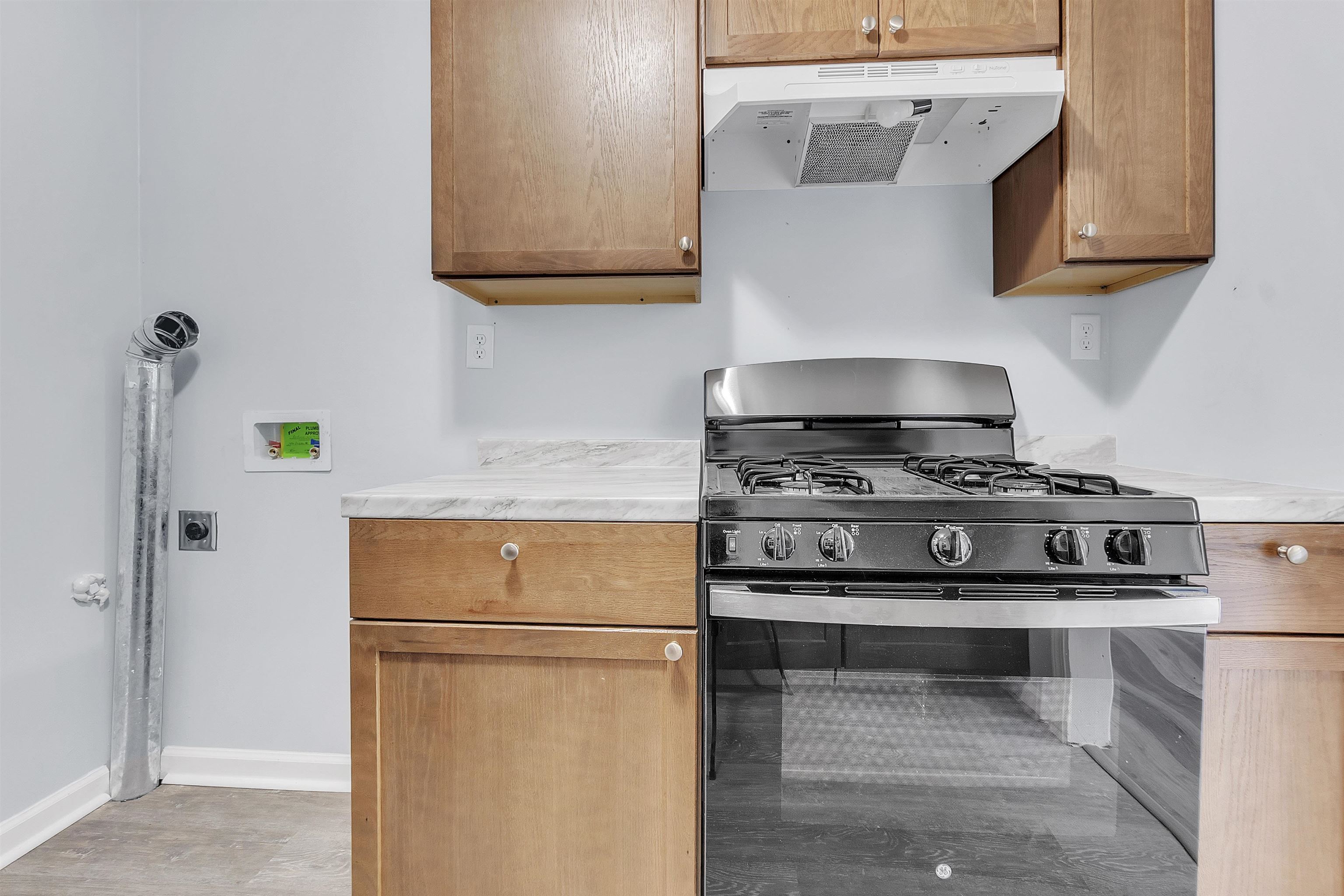 1682 Pendleton Street Memphis, TN 38114 - Photo 11 of 36 a kitchen with a stove and a refrigerator