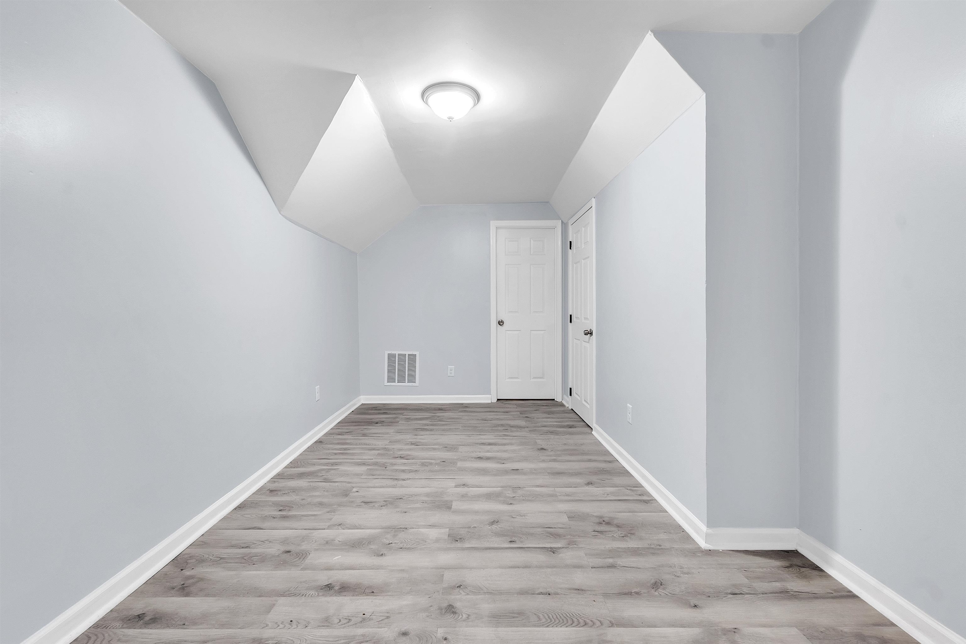 1682 Pendleton Street Memphis, TN 38114 - Photo 14 of 36 an empty room with wooden floor and windows