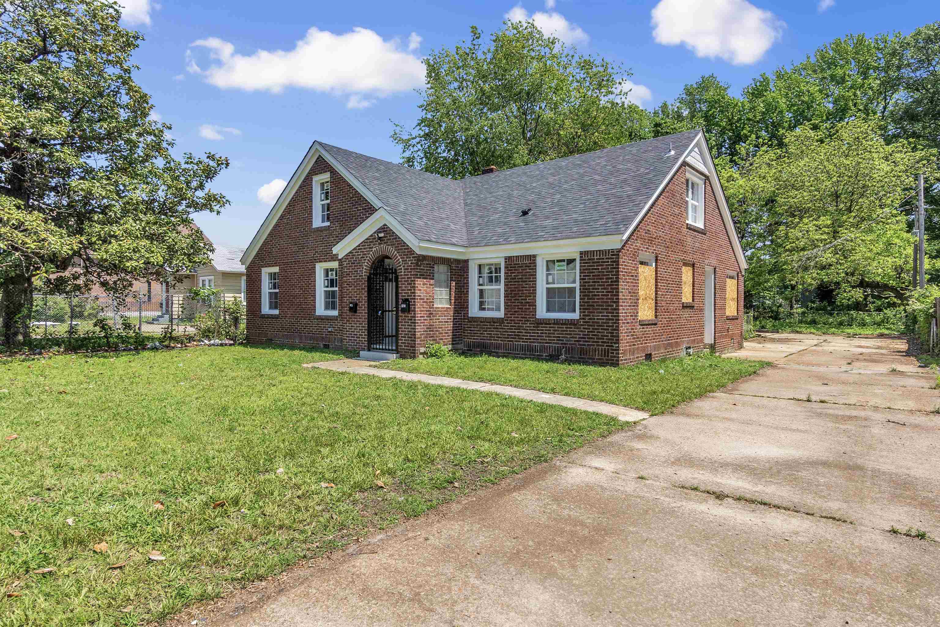 1682 Pendleton Street Memphis, TN 38114 - Photo 2 of 36 a front view of a house with a garden and trees