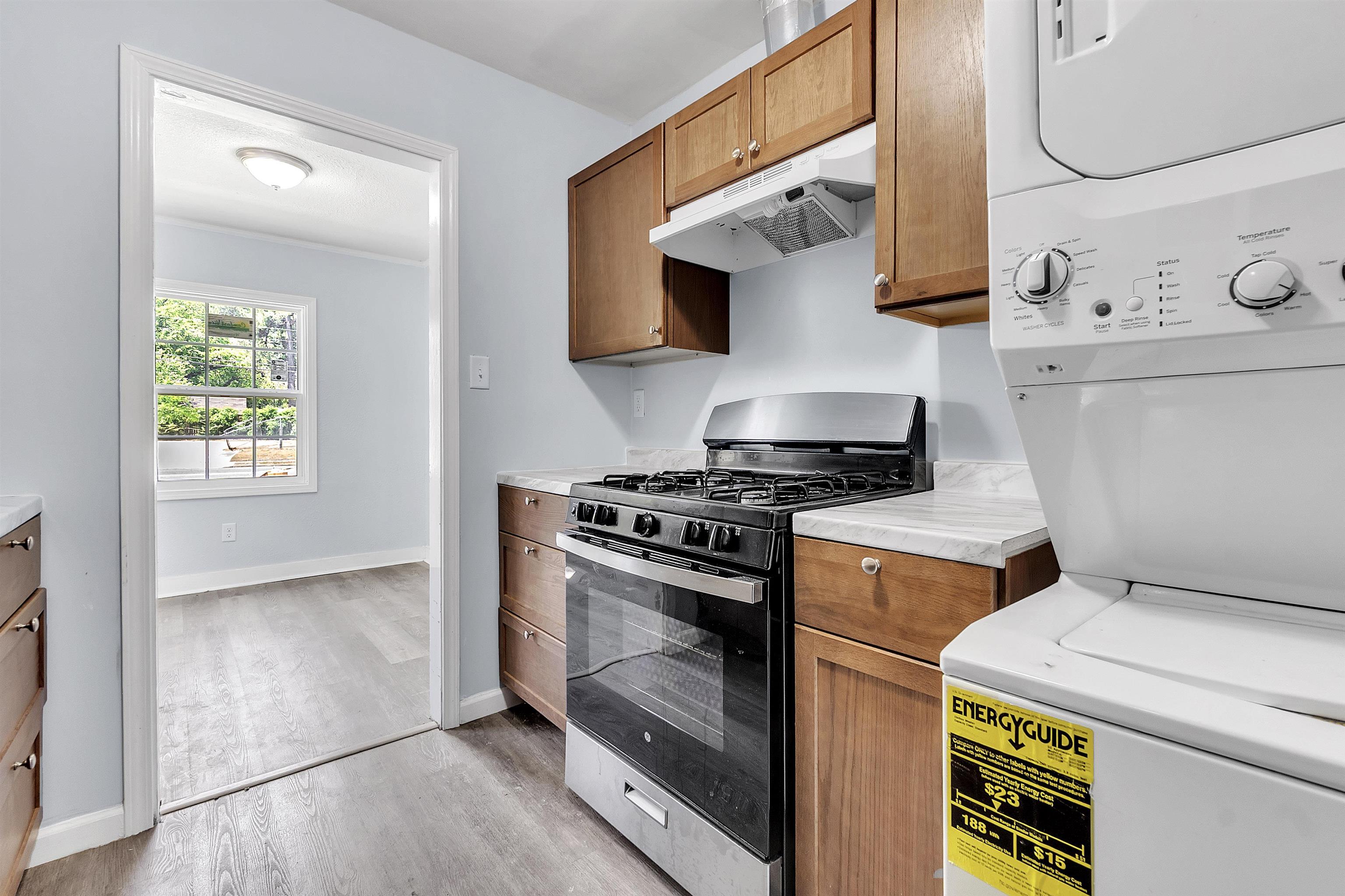 1682 Pendleton Street Memphis, TN 38114 - Photo 24 of 36 a kitchen with a stove and a microwave