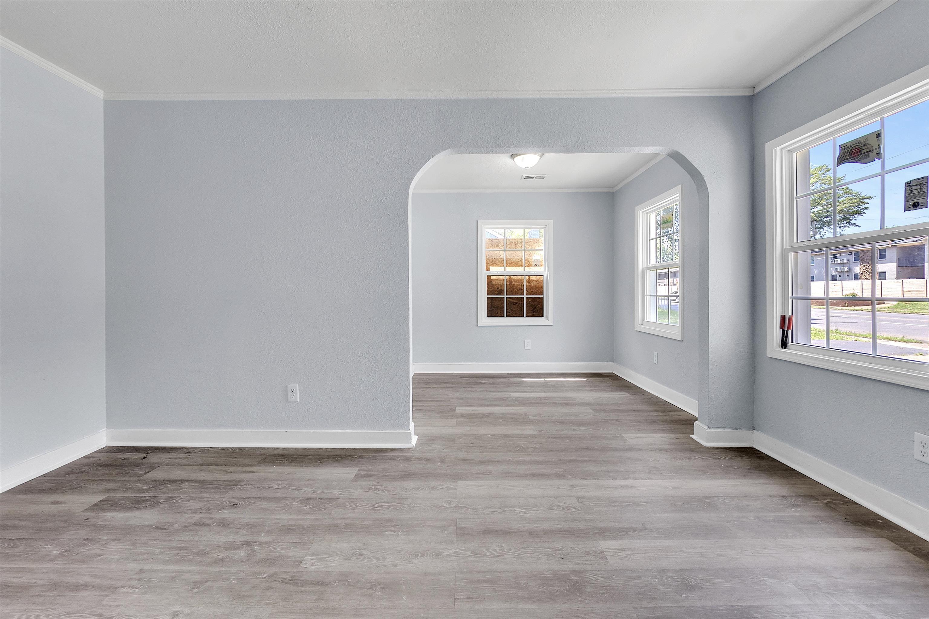 1682 Pendleton Street Memphis, TN 38114 - Photo 27 of 36 an empty room with wooden floor and windows