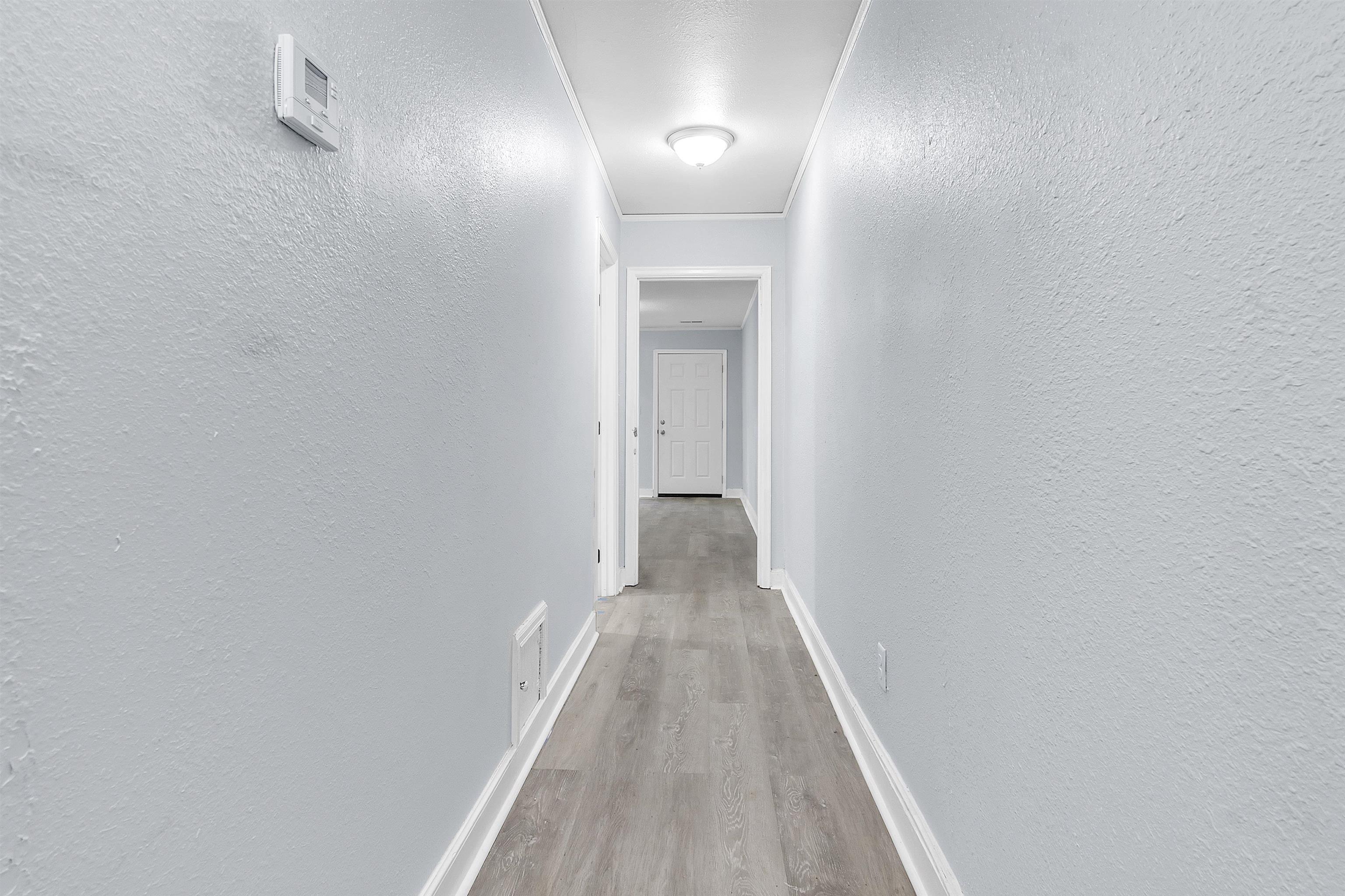 1682 Pendleton Street Memphis, TN 38114 - Photo 28 of 36 a view of a hallway with wooden floor