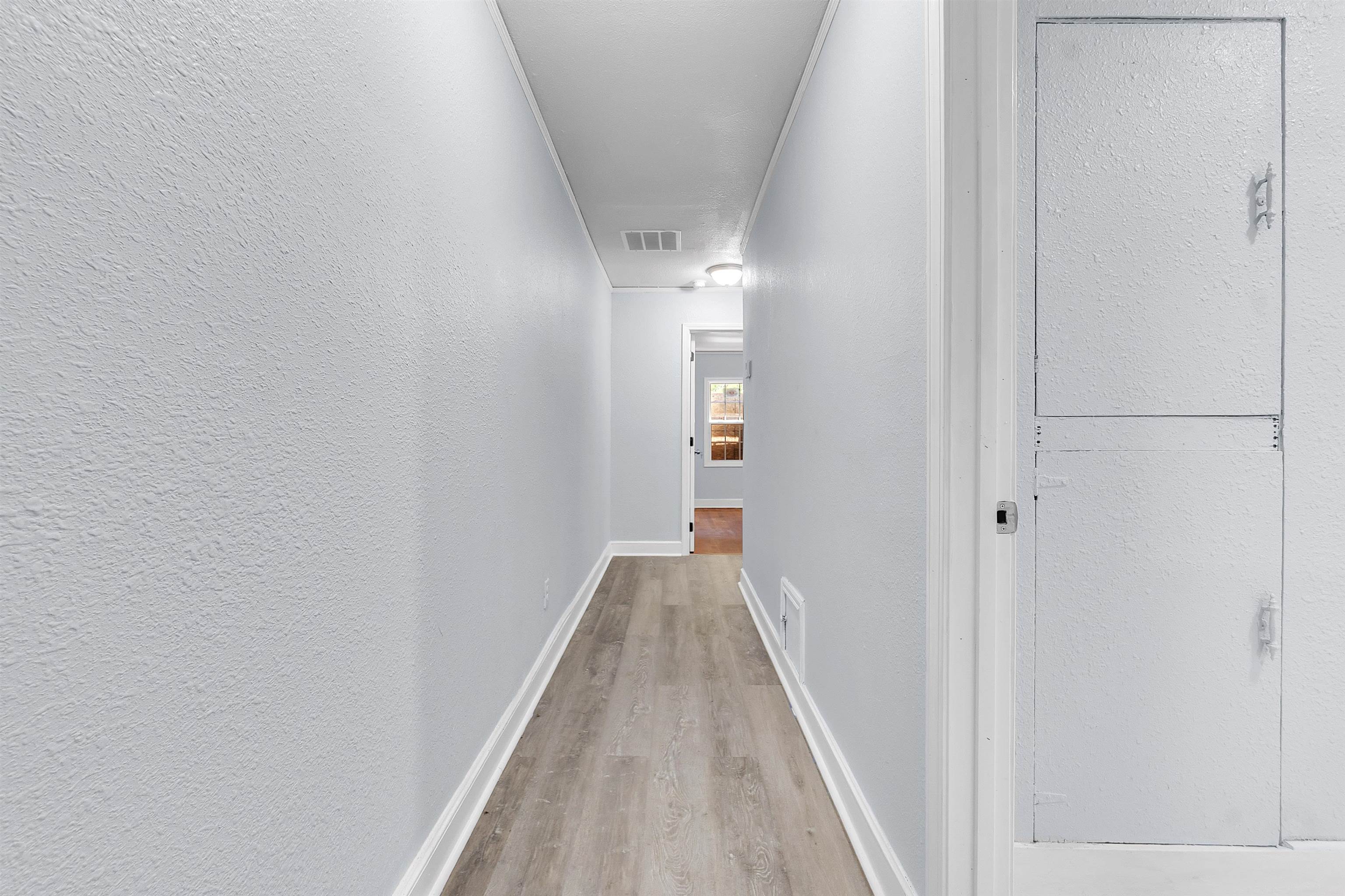 1682 Pendleton Street Memphis, TN 38114 - Photo 33 of 36 a view of a hallway with wooden floor and staircase