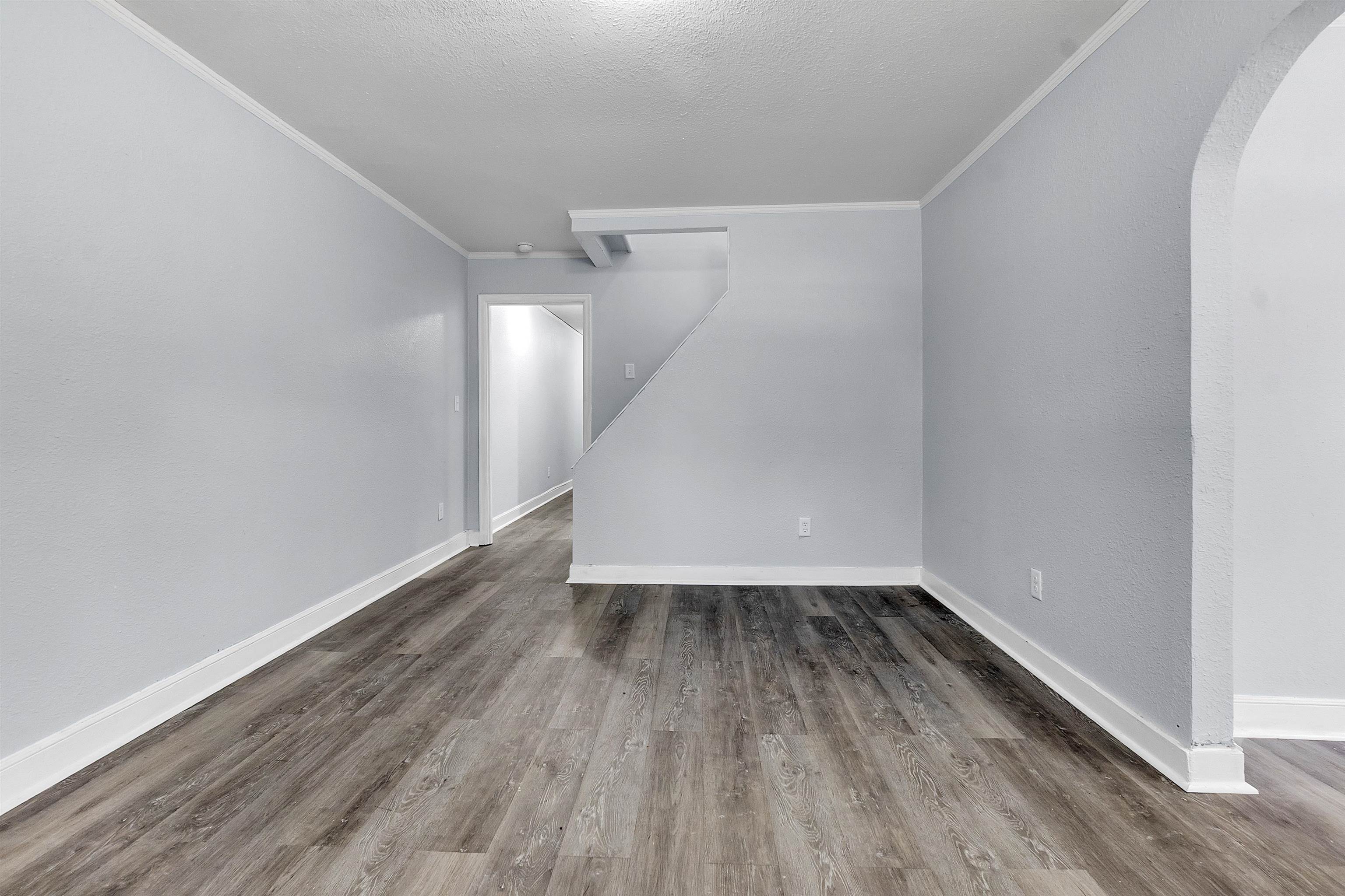 1682 Pendleton Street Memphis, TN 38114 - Photo 34 of 36 a view of a room with wooden floors and white walls