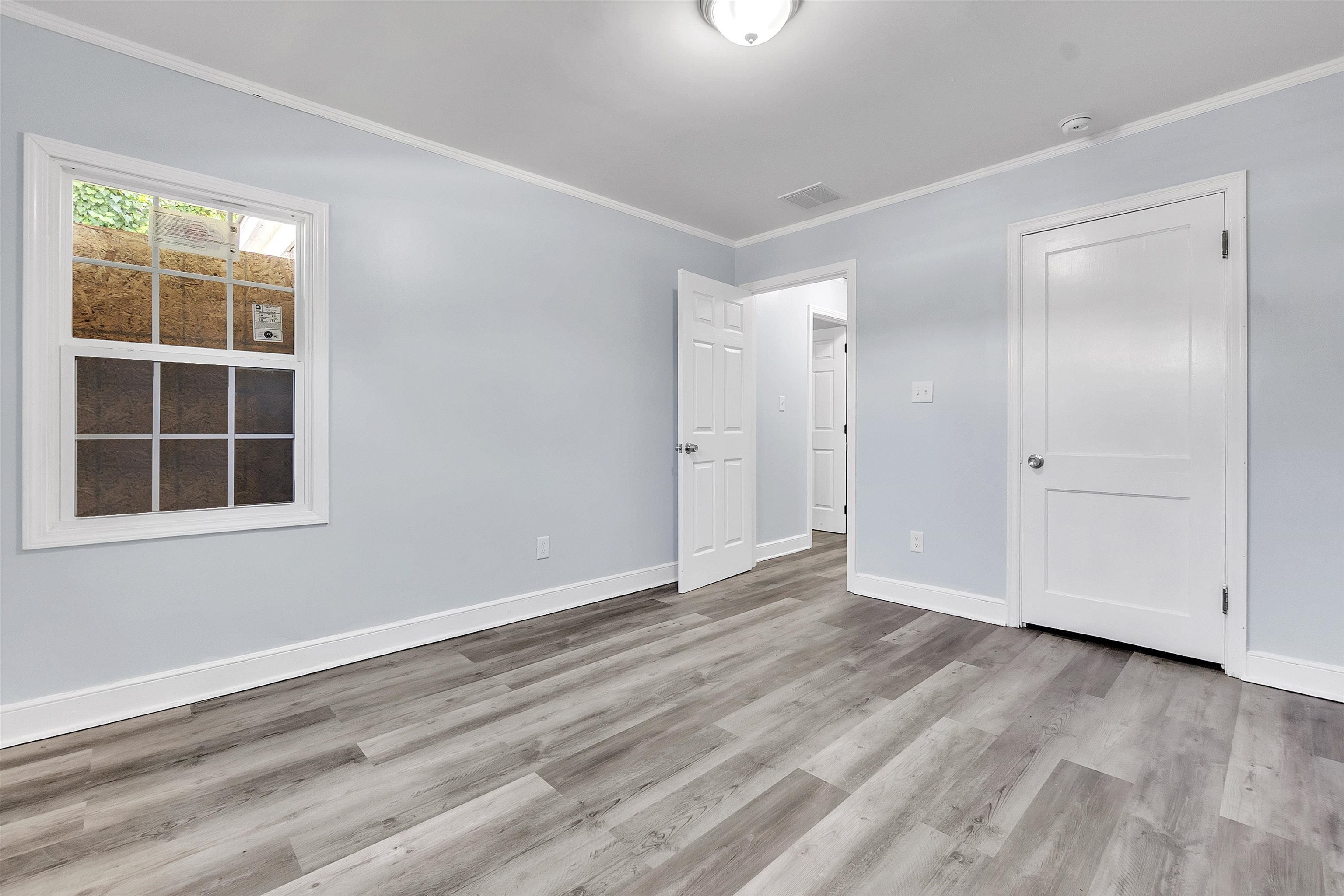 1682 Pendleton Street Memphis, TN 38114 - Photo 4 of 36 a view of empty room with wooden floor and window