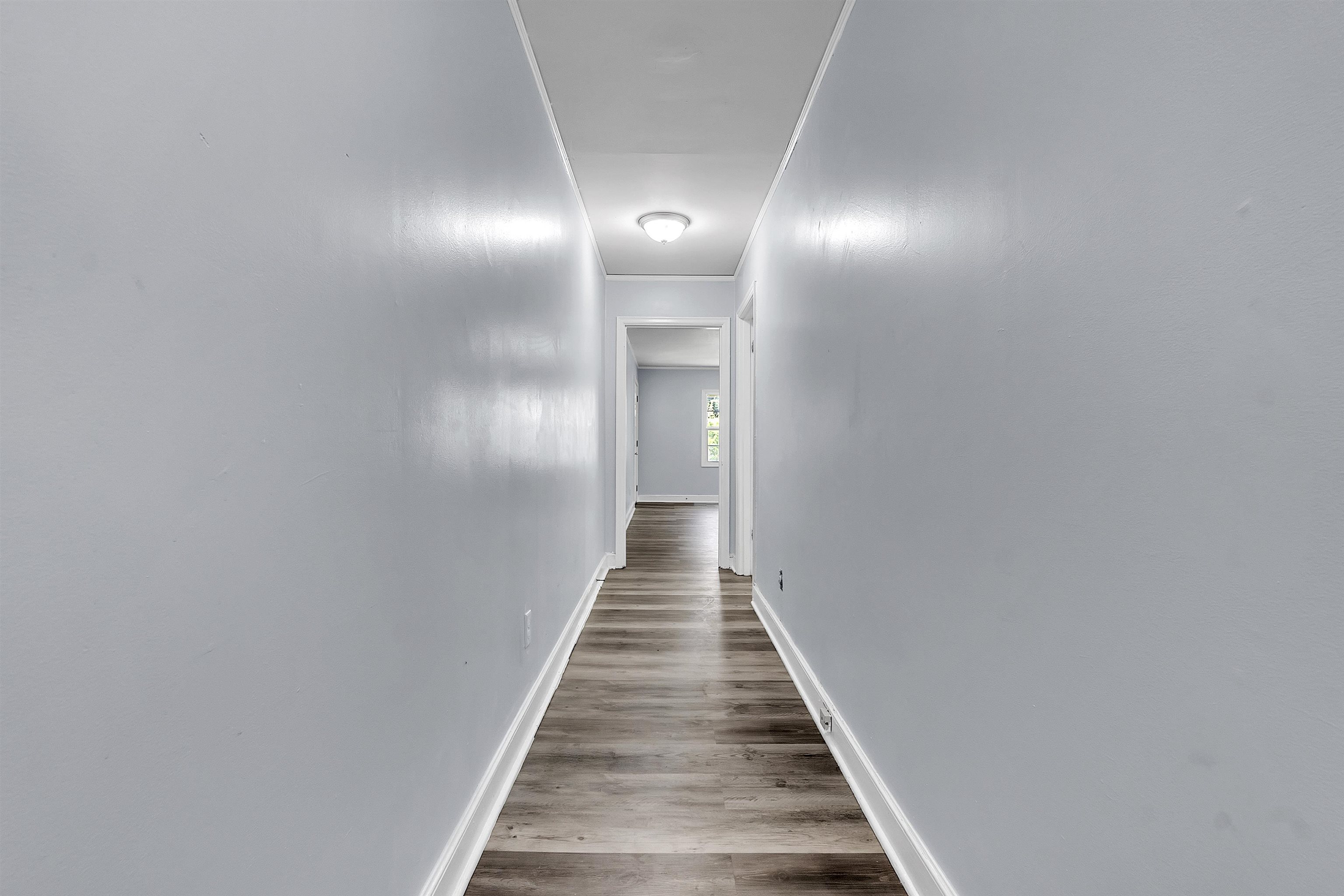 1682 Pendleton Street Memphis, TN 38114 - Photo 6 of 36 a view of a hallway with wooden floor