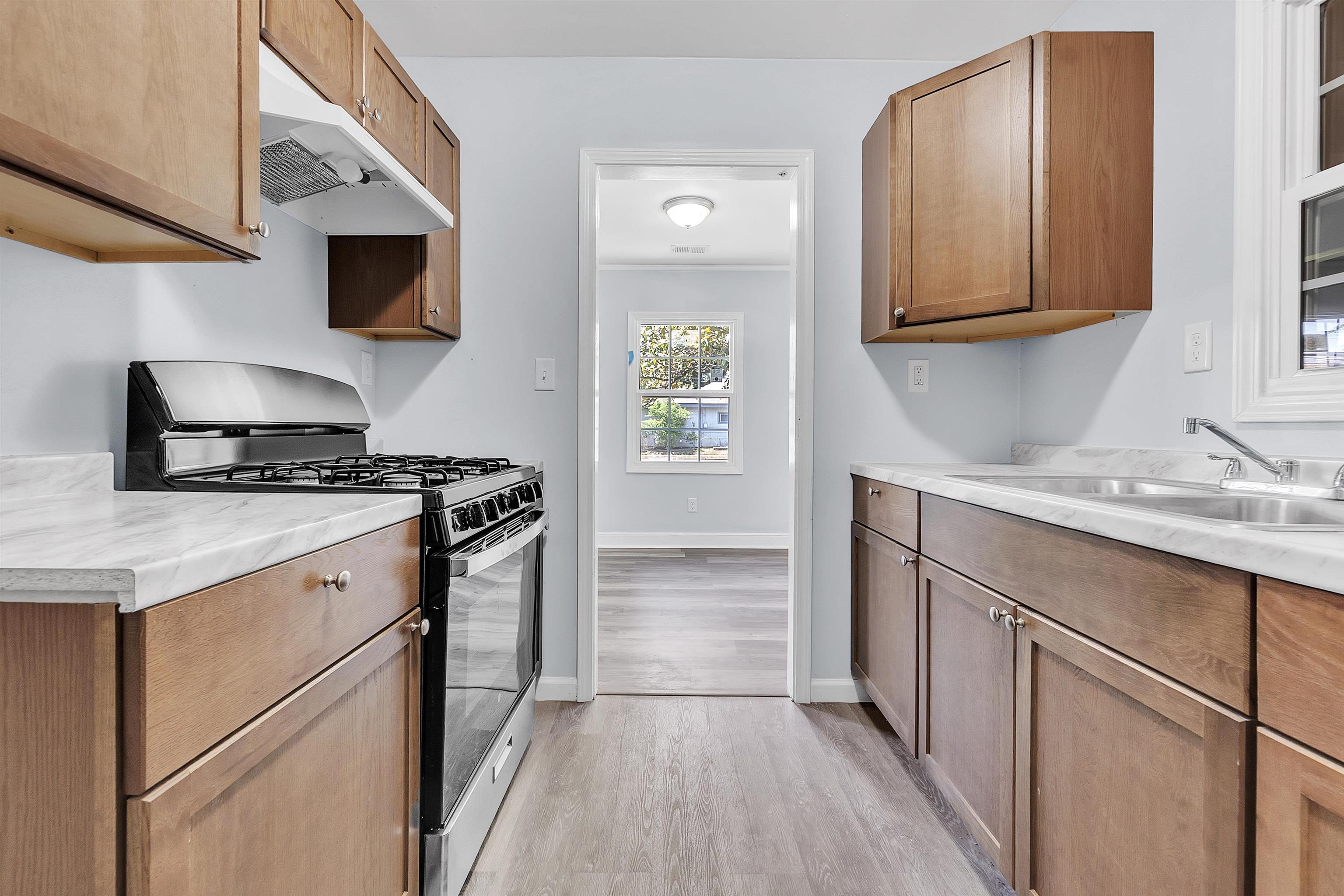 1682 Pendleton Street Memphis, TN 38114 - Photo 10 of 36 a kitchen with stainless steel appliances granite countertop a sink stove and microwave