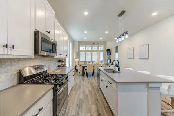 a kitchen with lots of counter space and stainless steel appliances
