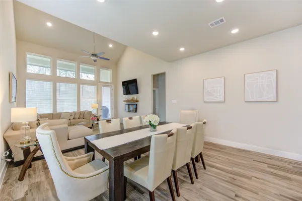 a view of a dining room with furniture a couch and wooden floor