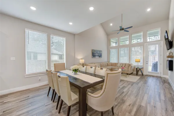 a view of a dining room with furniture large windows and wooden floor