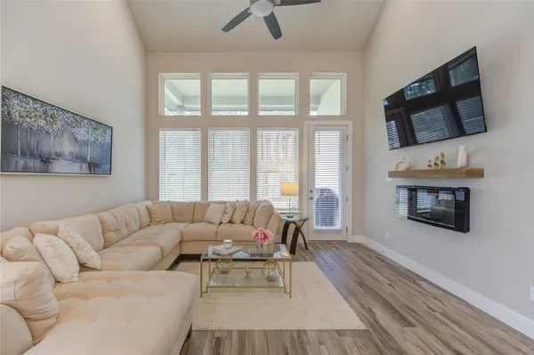 a living room with furniture a flat screen tv and a fireplace
