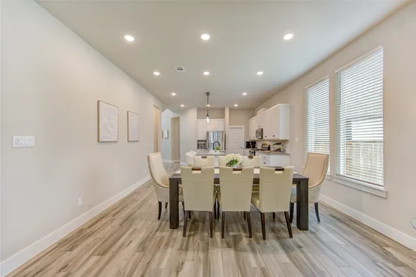 a dining room with furniture and wooden floor