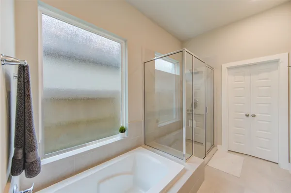a bathroom with a shower and a glass door