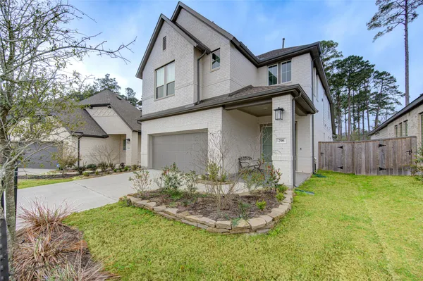 a view of a house with a big yard and large tree