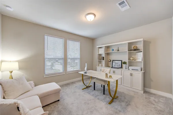 a living room with furniture a window and a table
