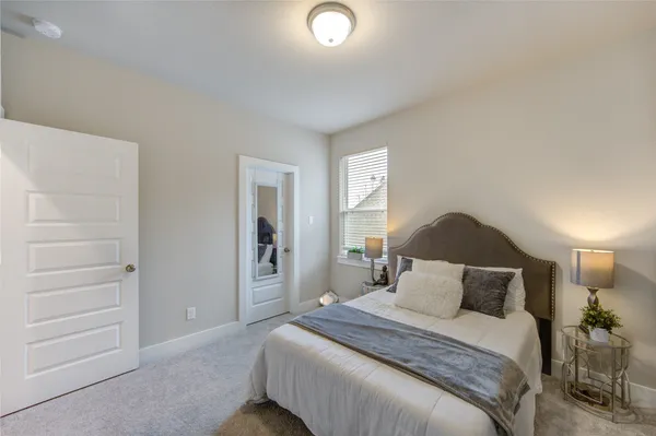 a bedroom with a bed and a night stand