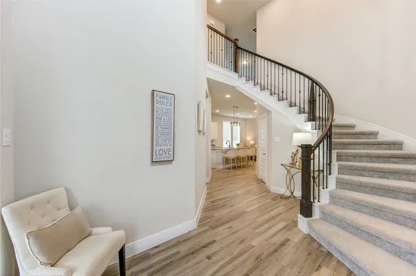 a view of entryway and hall with wooden floor