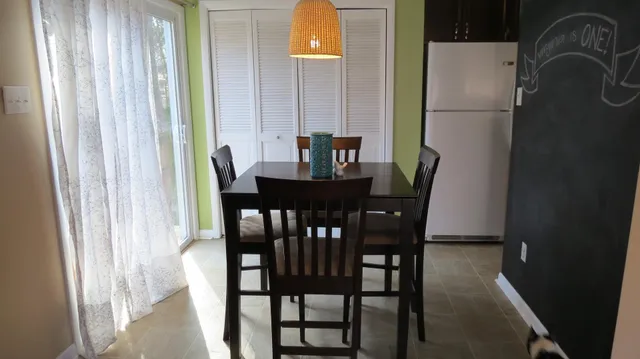 a view of a dining room with furniture and window