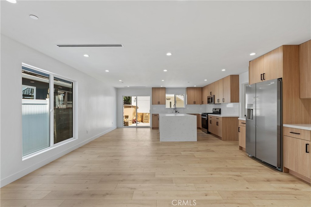13901 Runnymede Street Van Nuys, CA 91405 - Photo 11 of 47 a large kitchen with kitchen island a refrigerator a sink dishwasher with a stove and refrigerator