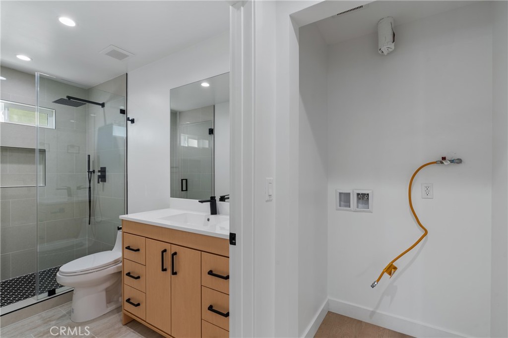 13901 Runnymede Street Van Nuys, CA 91405 - Photo 19 of 47 a bathroom with a sink a toilet and shower