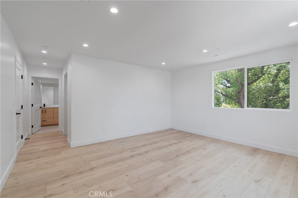 13901 Runnymede Street Van Nuys, CA 91405 - Photo 30 of 47 an empty room with large windows and natural light