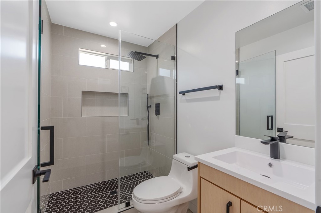13901 Runnymede Street Van Nuys, CA 91405 - Photo 34 of 47 a bathroom with a sink toilet and shower