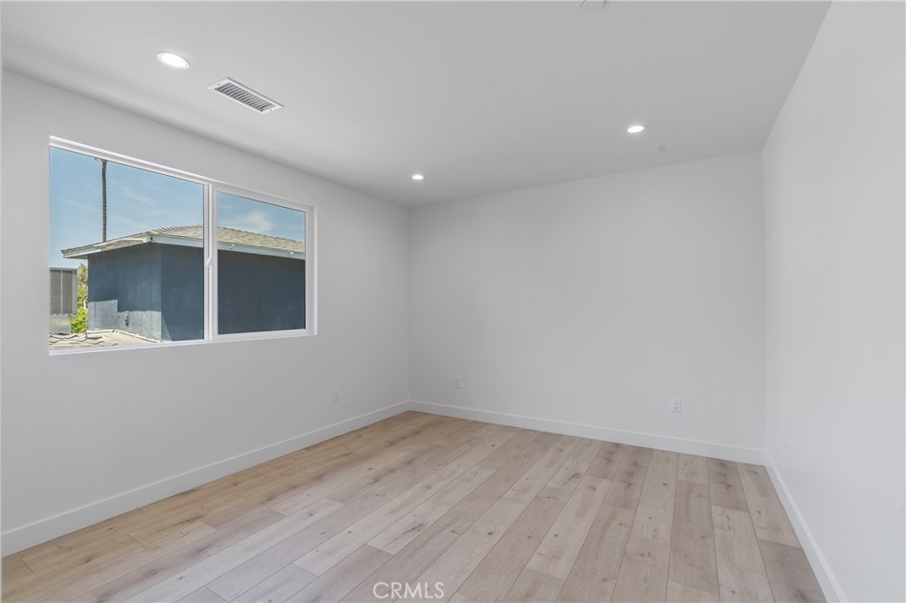 13901 Runnymede Street Van Nuys, CA 91405 - Photo 35 of 47 an empty room with wooden floor and windows