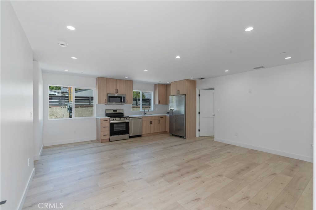 13901 Runnymede Street Van Nuys, CA 91405 - Photo 39 of 47 a kitchen with stainless steel appliances a refrigerator and a stove top oven