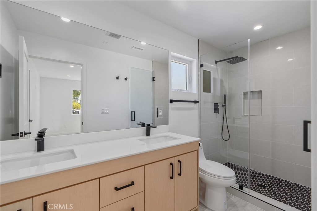 13901 Runnymede Street Van Nuys, CA 91405 - Photo 42 of 47 a bathroom with a sink a toilet and shower