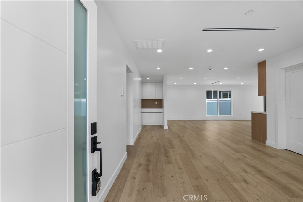 13901 Runnymede Street Van Nuys, CA 91405 - Photo 7 of 47 a view of a big room with wooden floor and a kitchen